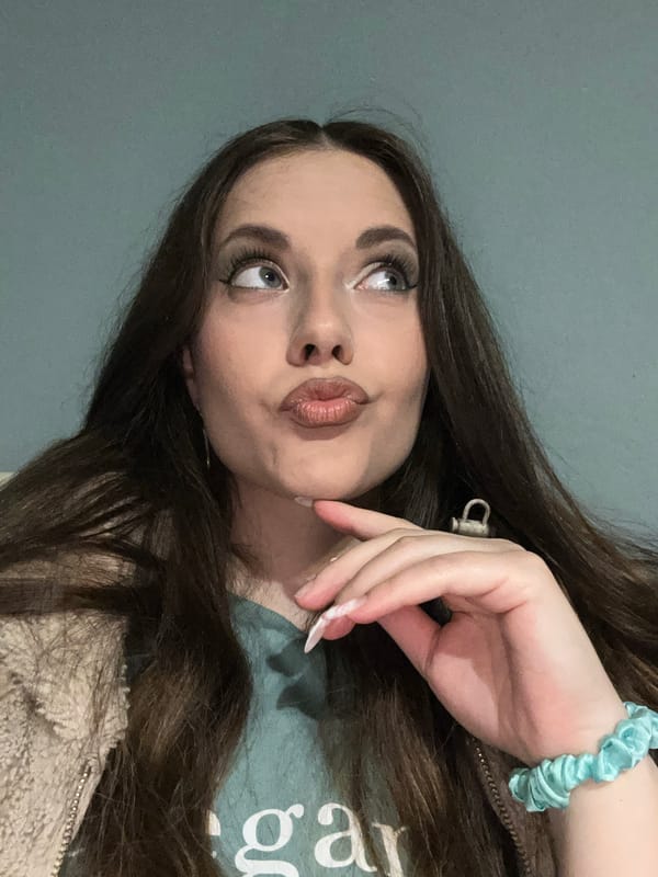 Young woman poses for multiple photos in green shirt