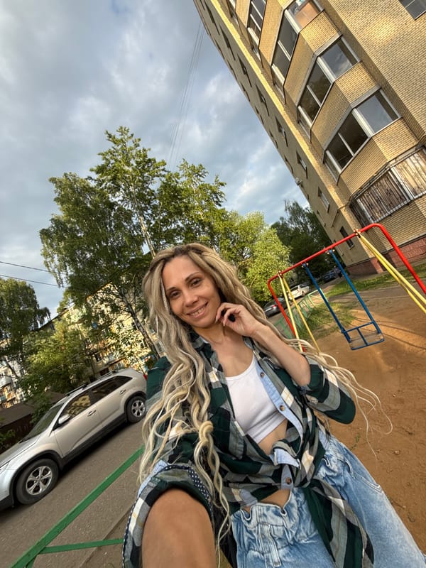 Woman poses smiling in casual attire in Rusanovo