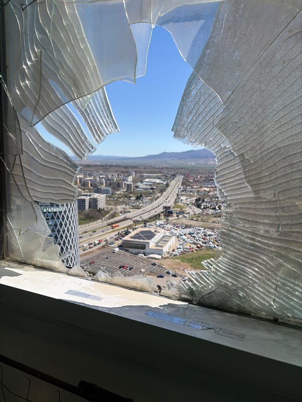 Broken high-rise window frames Sofia cityscape view