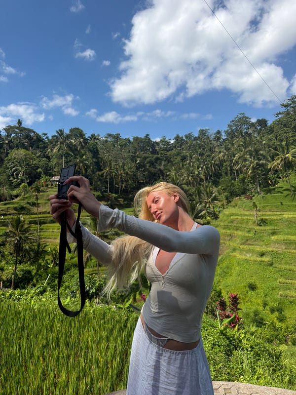 Tourists photograph, zip-line through Tegallalang rice terraces in Indonesia