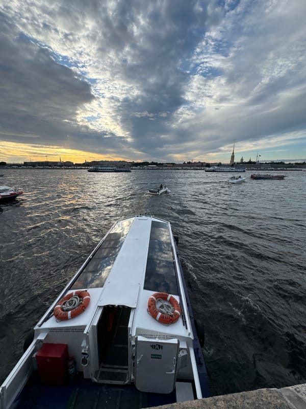 Evening on the Neva: boats, flags, and the granite embankment