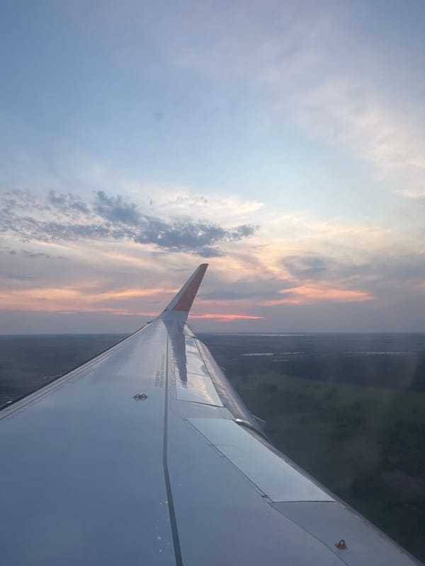 Aircraft passenger captures colorful sky view from airplane window