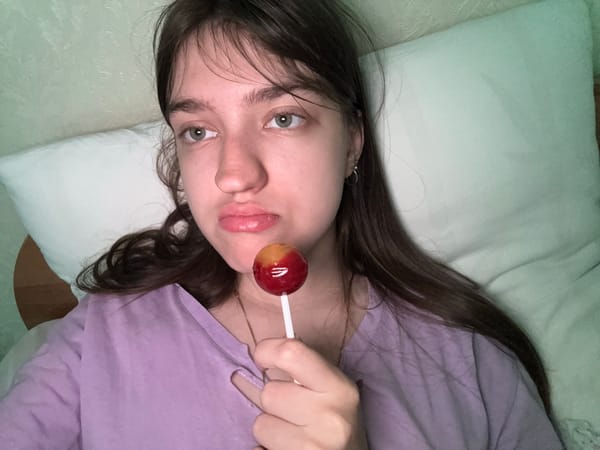 Woman spends morning in bed with lollipop and kitten