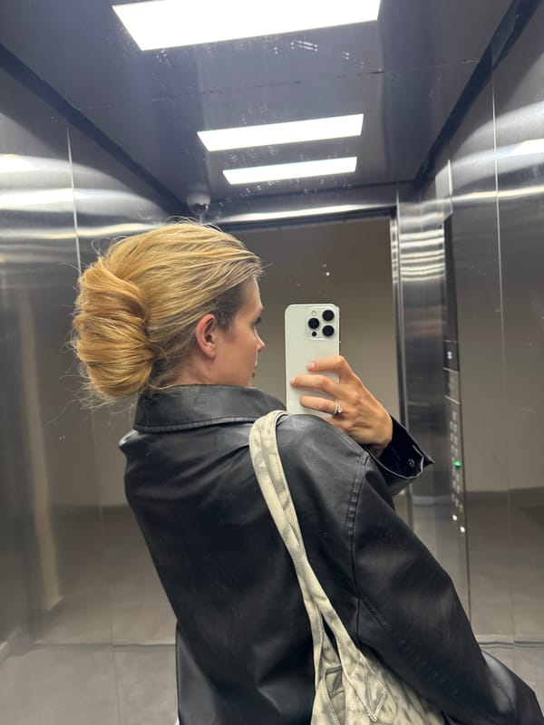 Woman Takes Elevator Selfies in Black Leather Jacket