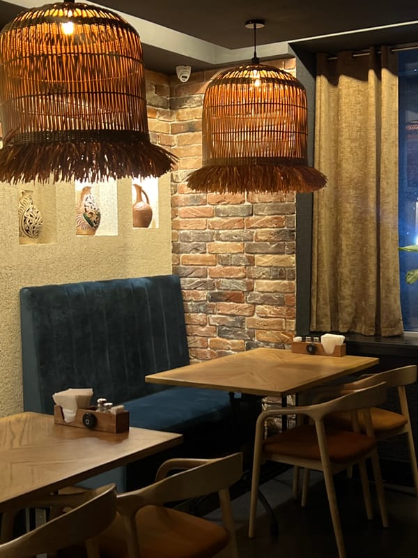 Inside a Moscow restaurant with mixed seating and warm lighting