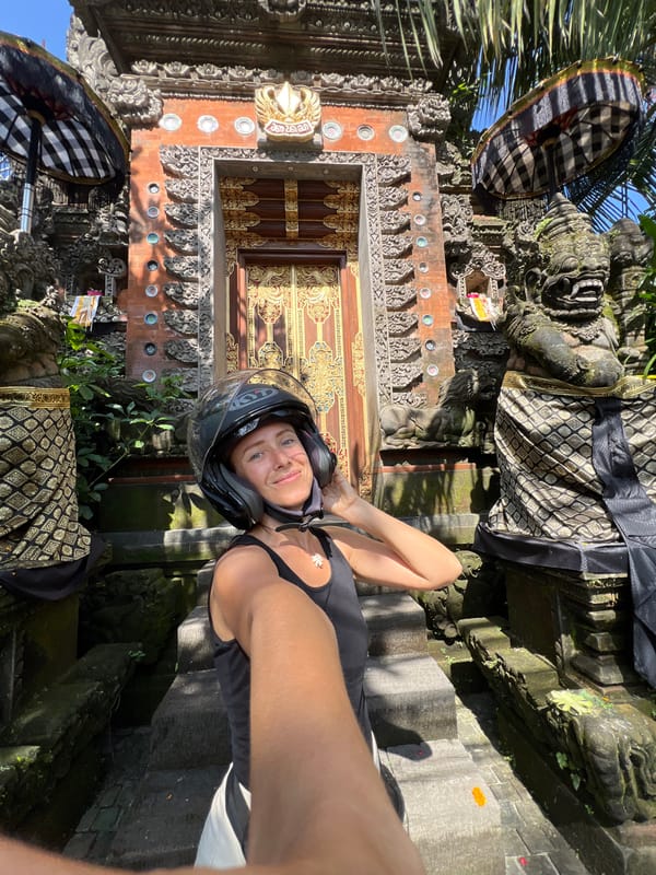 Tourist documents ornate Balinese temple architecture in Petulu village