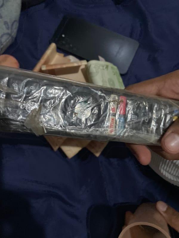 Domestic scenes with Venezuelan currency and electronics documented indoors