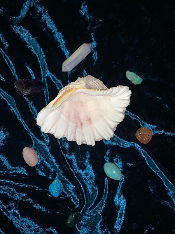Tarot cards, crystals, sketchbooks, and portrait shots on velvet
