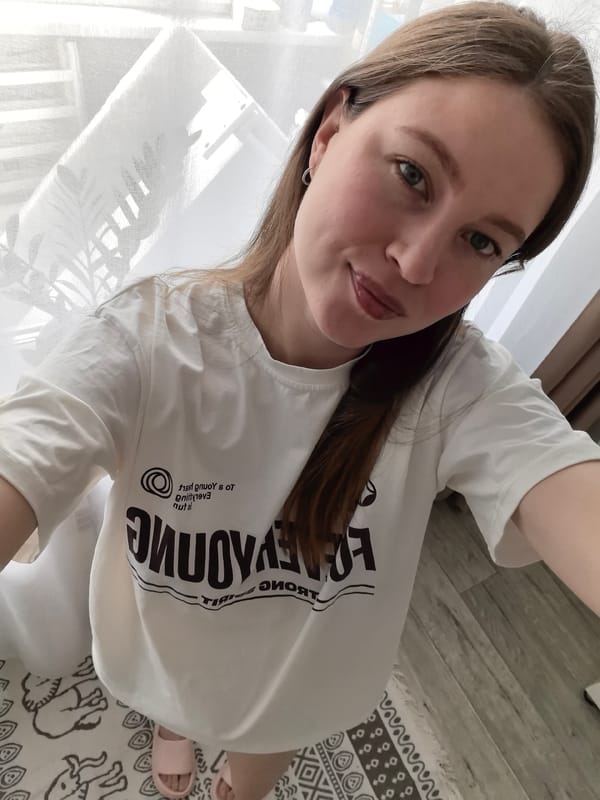 Woman takes selfie in reversed text shirt in Omsk