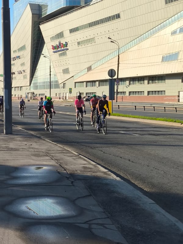 Cyclists ride through urban area in early morning hours