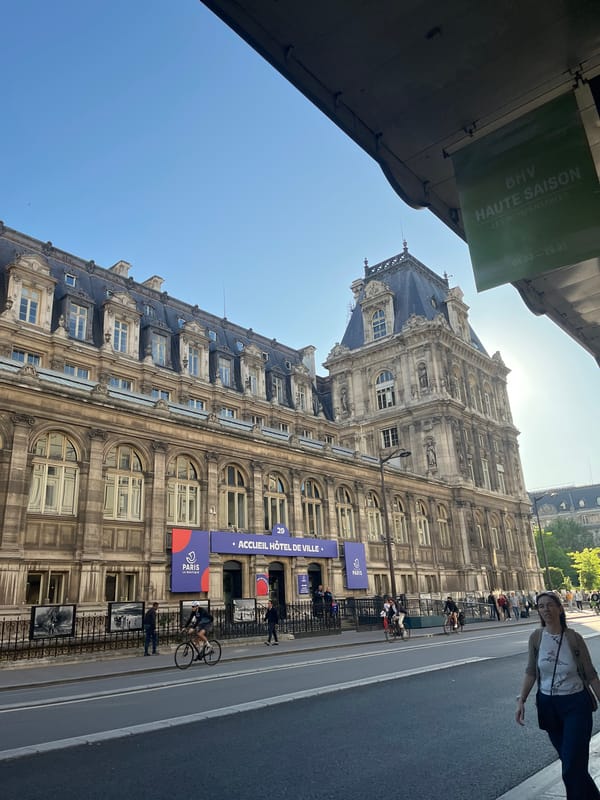 Woman enjoys afternoon beverage on sunny Paris street