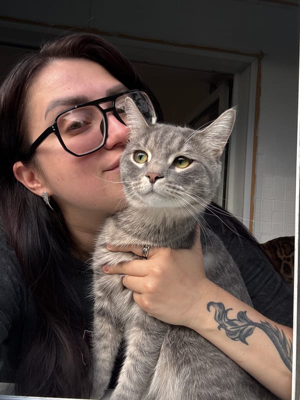 Pet owner photographed with cats and rats indoors