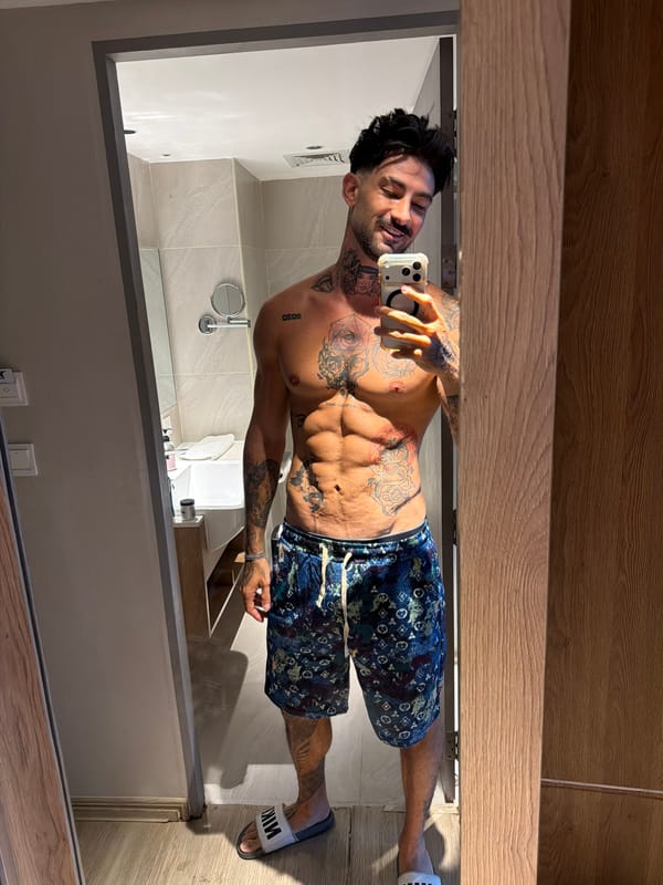 Tattooed man takes mirror selfie in Patong, Thailand