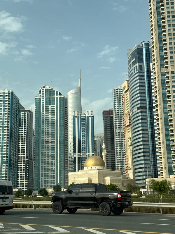 Dubai skyline observed under partly cloudy afternoon skies