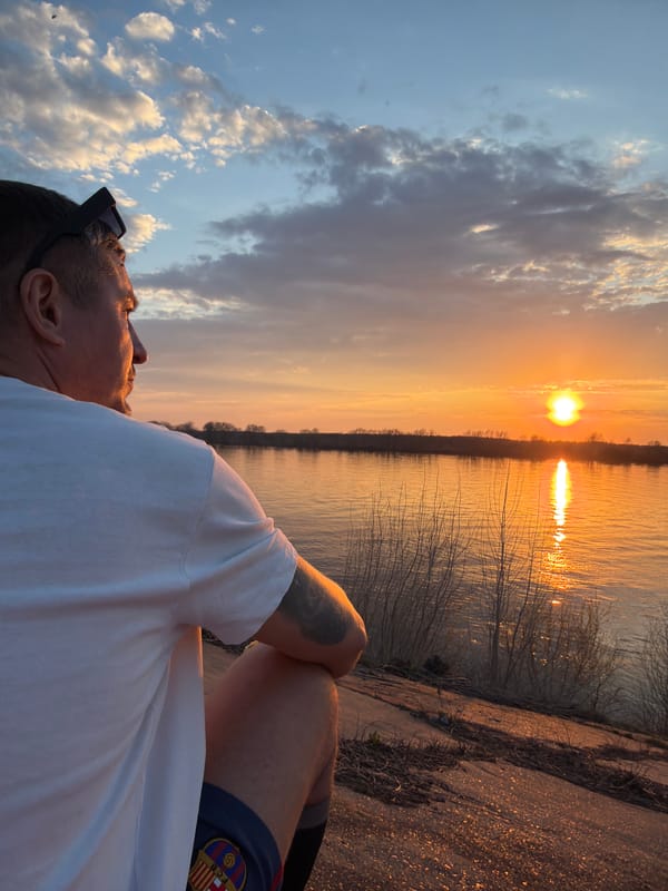 Person enjoys sunset moment by Kama River in Chaikovsky
