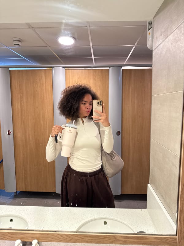Person takes selfie with drink in London restroom