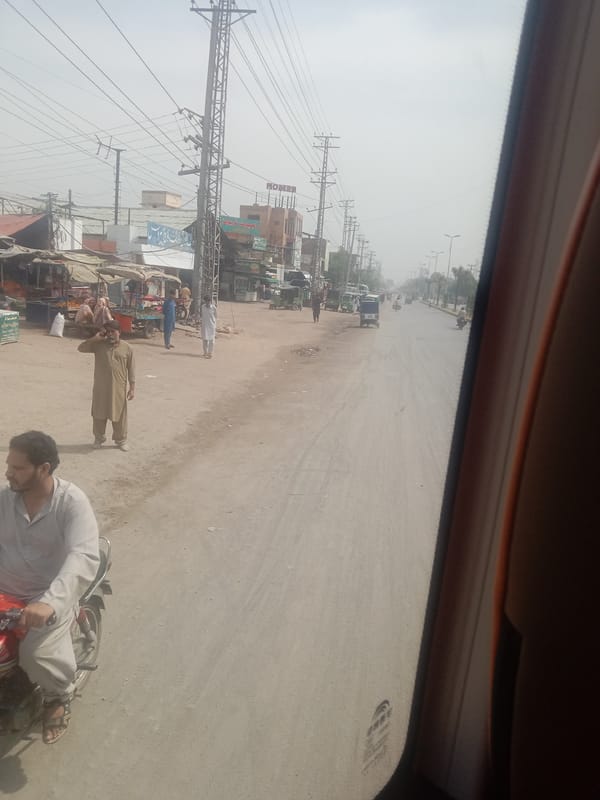 Morning street view captured from vehicle in Pakistan