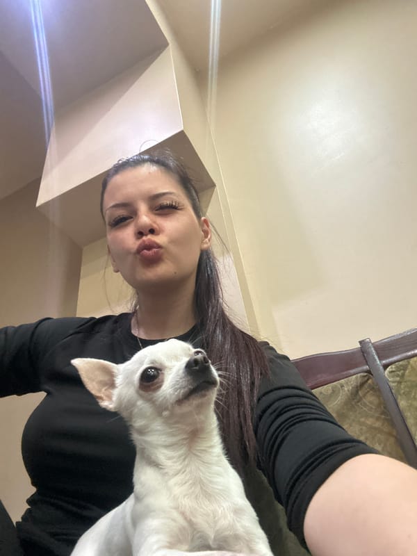 Woman takes selfies with small white dog in Sliven