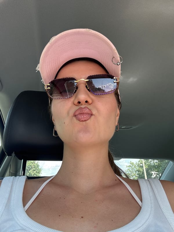Car selfies and a motorcyclist moving through city traffic