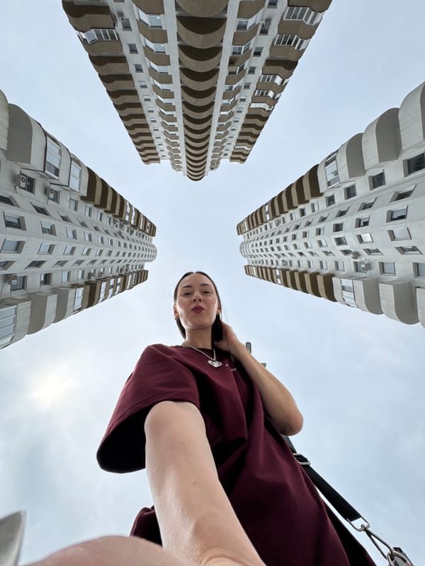 Woman takes selfies between apartment buildings in Sochi