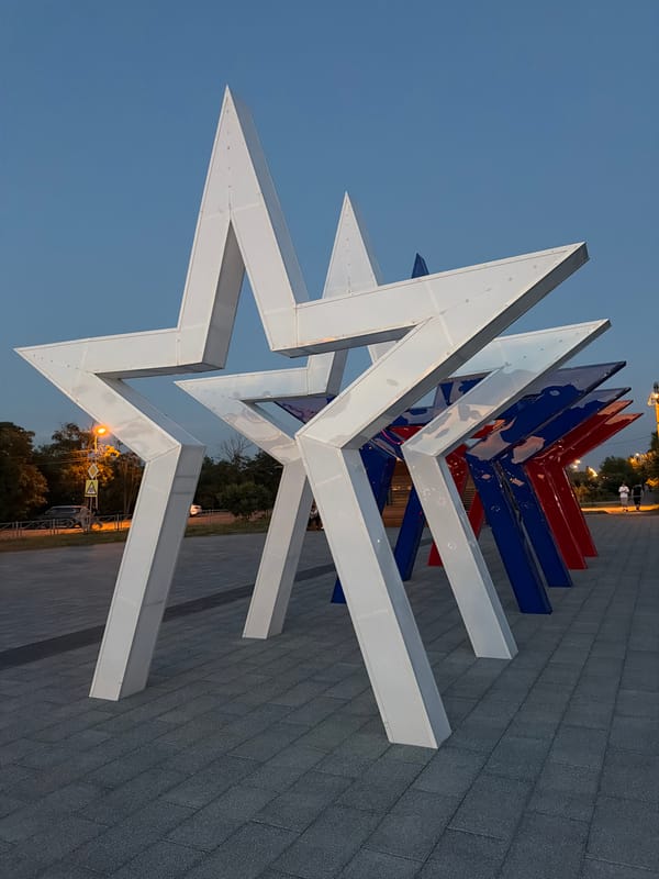Metallic star sculptures at dusk in Budyonnovsk, Russia