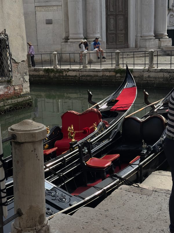 Venice canal walk with gondolas and classic architecture