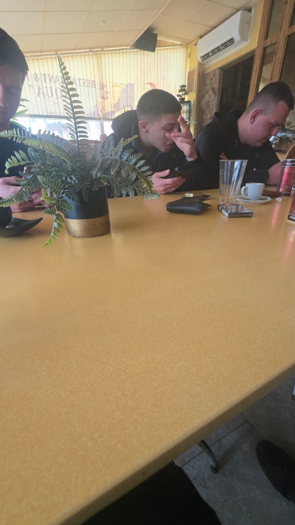 Two men dine at restaurant table in Balgarevo