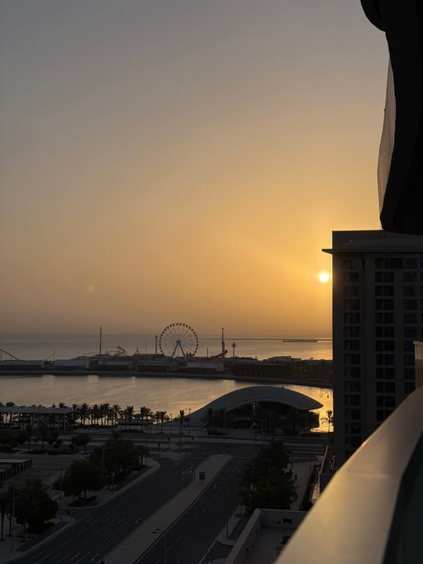 Golden hour over Lusail's waterfront, coffee in hand