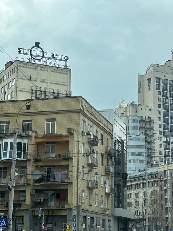 Morning street scenes captured across central Kyiv show traffic, buildings