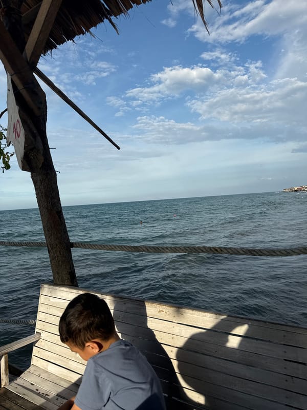 Families enjoy quiet beach day in Lhokseumawe, Indonesia