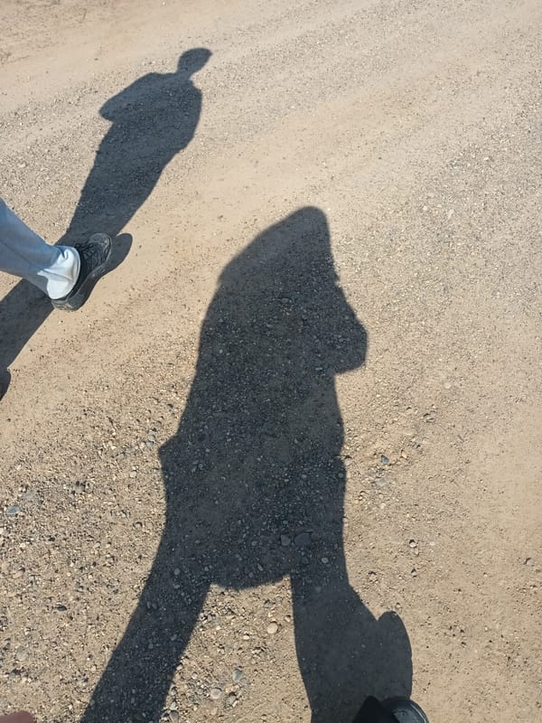 Two people photographed on dirt road in Ольховка, Russia