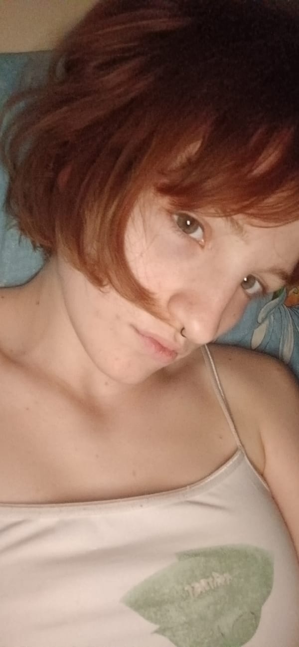 Woman poses playfully on bed in Podgorica apartment