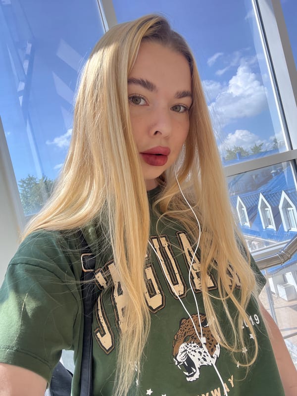 Selfie session across a Krasnodar interior, green tee throughout