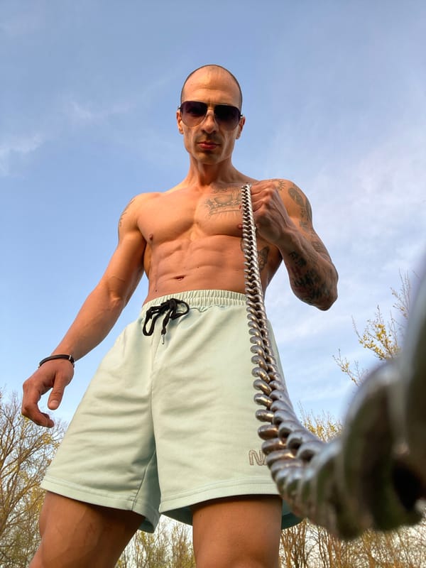 Shirtless man photographed against blue sky in Pleven, Bulgaria