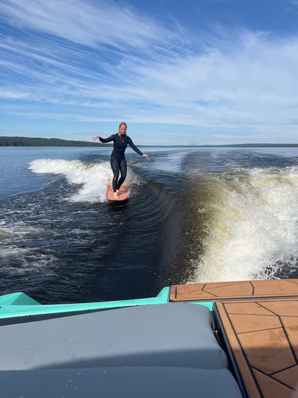 Wake surfing behind a boat on a Russian lake