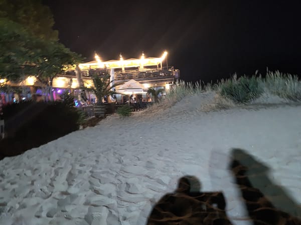 Moonlit beach night out with rides, bars, and hotel nearby