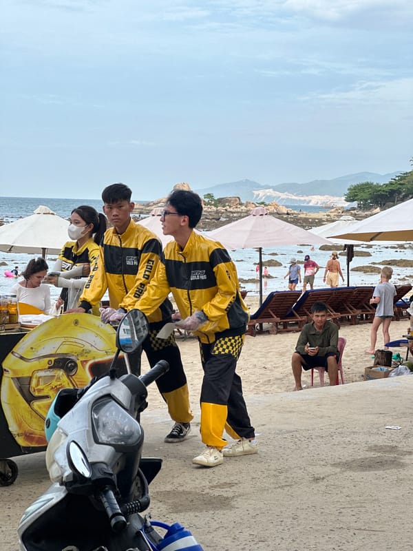 Nha Trang beachfront buzzing with vendors, swimmers, and scooters
