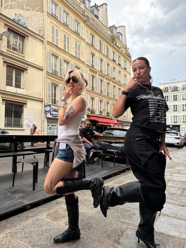 Young women photograph casual street scenes in Paris afternoon