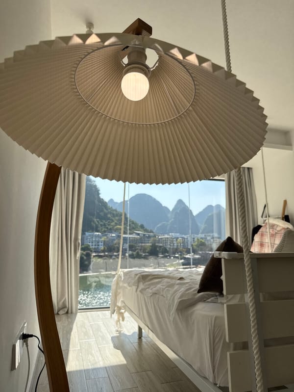 Tourist documents scenic hotel stay overlooking Li River, Guilin