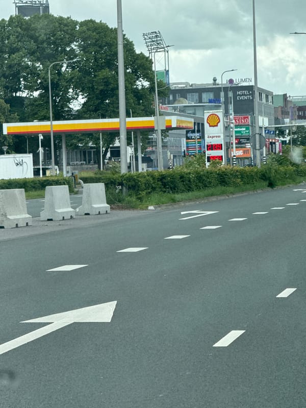Driver navigates through commercial Zwolle on cloudy morning