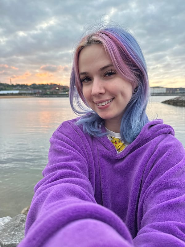 Woman takes sunset selfies at Gijón waterfront