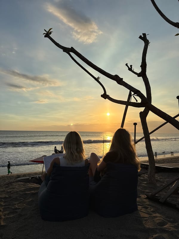 Sunset gathering observed at North Kuta beach with statuary