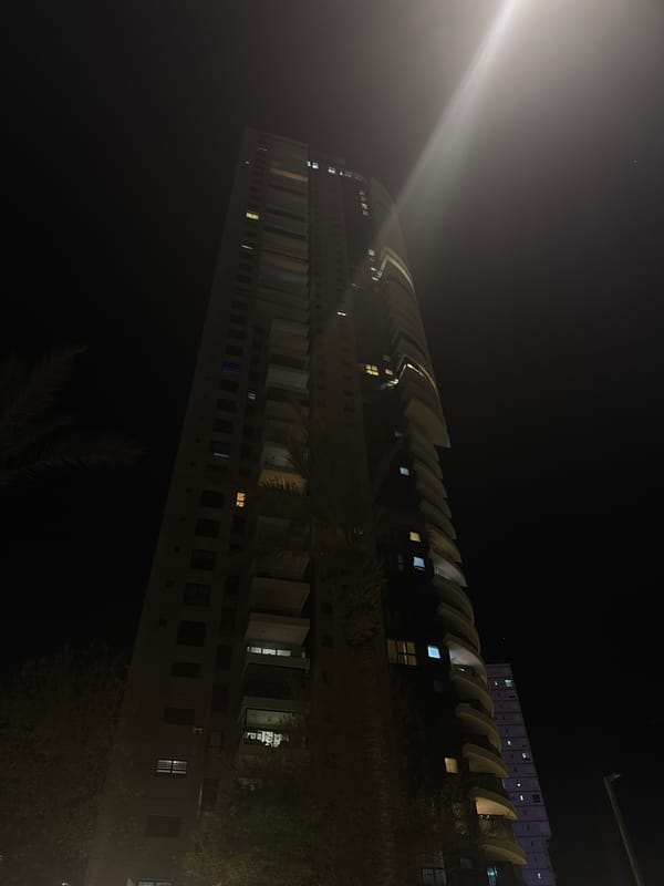 Night photography captures Bat Yam residential buildings with distinctive architecture