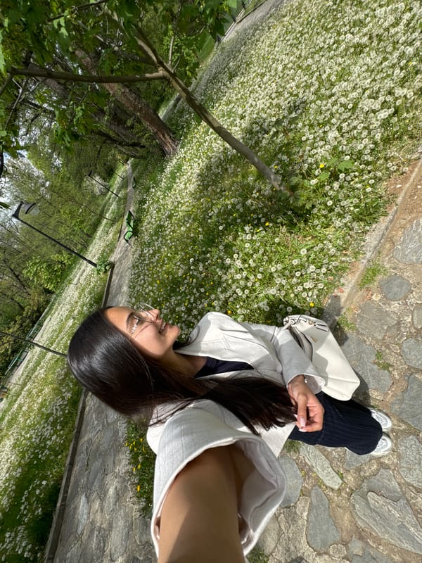 Woman enjoys spring day in Dupnitsa park dandelion field