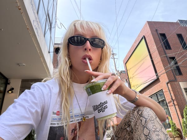 Woman enjoys coffee at outdoor Seoul cafe early morning