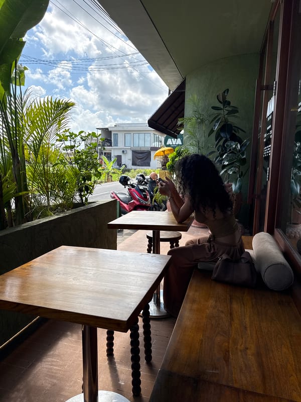 Phones out at a shaded patio table in Mengwi