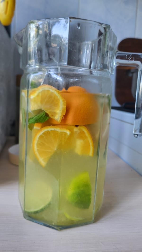 Citrus-infused drinks and fresh oranges on a tabletop