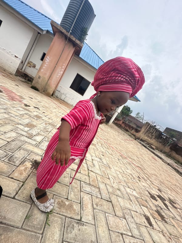Jos street life features young girl in traditional dress