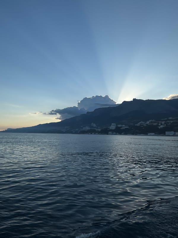 Sunlight through mountains captured in Ukrainian coastal village