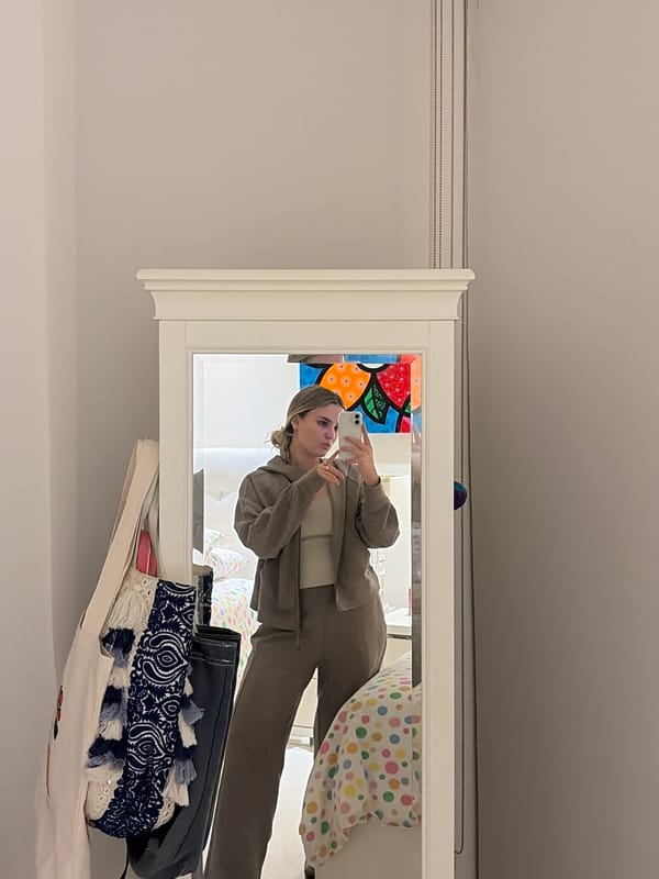 Woman takes mirror selfie in beige suit in Key Biscayne